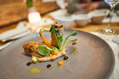 a plate with a piece of food on a table at Berggasthof Platzlalm in Kaltenbach