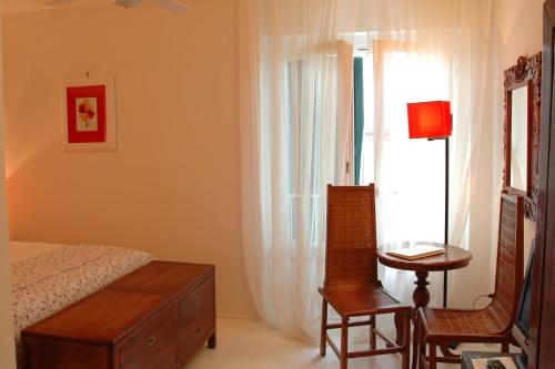a bedroom with a bed and a table and a window at Il San Francesco Charming Hotel in Sabaudia