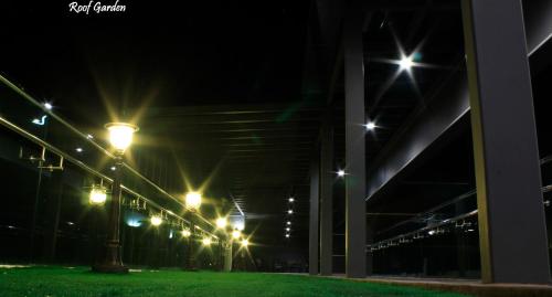 a row of street lights at night at H2H - Marine Home @ Majestic Ipoh (8~10 Guests) in Ipoh