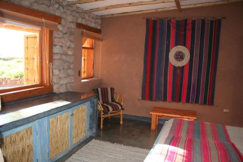 a bedroom with a bed and a flag on the wall at Casita La Brea in San Pedro de Atacama
