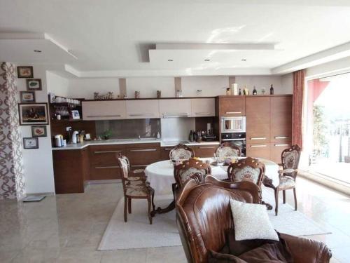 a kitchen with a table and chairs in a room at Apartmán Deluxe in Banská Bystrica