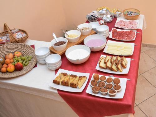 a table with appetizers and other foods on it at Albergo Casavecchia in Tiarno di Sopra