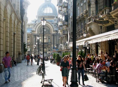 una calle de la ciudad con gente caminando por una calle en Studio Confort, en Bucarest