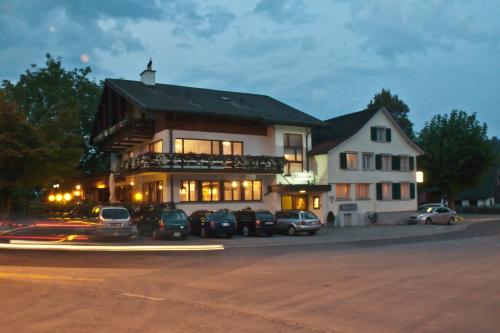 a large building with cars parked in front of it at Landgasthof Rössle ** Superior in Ruggell