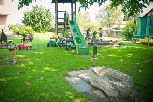 a park with a playground with a slide and a rock at Landgasthof Rössle ** Superior in Ruggell