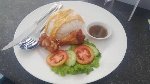 a plate of food with meat and tomatoes and bread at Bou Savy Villa in Siem Reap
