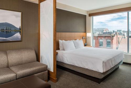 a hotel room with a bed and a window at Hyatt Place Portland Downtown - Old Port Square in Portland