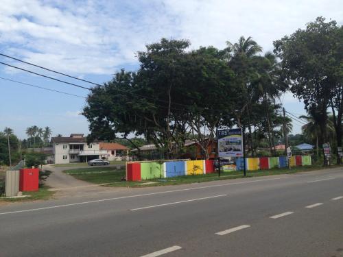 an empty street with a colorful fence on the side of a road at First Guest House in Kuantan