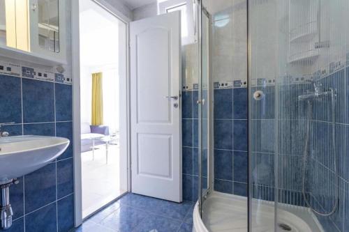 e bagno con doccia, lavandino e vasca. di Apartments Novak a Dubrovnik