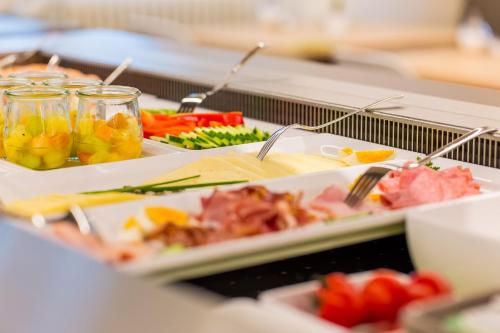 a buffet with several plates of food on a table at DIE KRONE - Hotel Garni in Kirchzarten