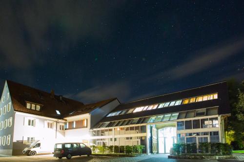 a building with a car parked in front of it at night at DIE KRONE - Hotel Garni in Kirchzarten