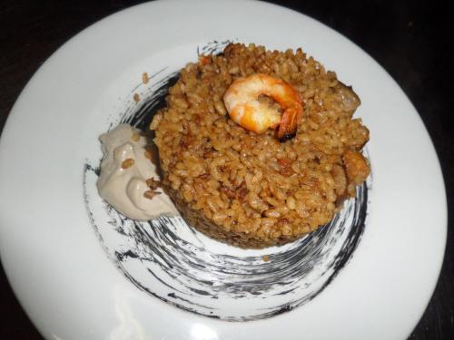 a plate of food with rice and a shrimp on it at Cal Manyo in Puigvert de Lérida