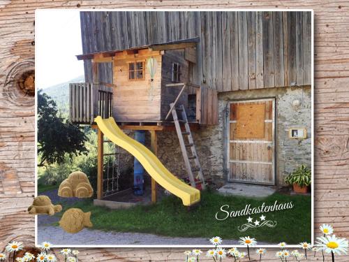 a picture of a play house with a slide at Fewo-Egger-Thalmann in Virgen