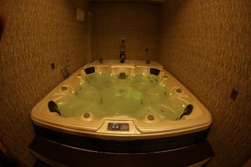 a jacuzzi bathtub in a bathroom with at Dilshad Palace Hotel in Duhok