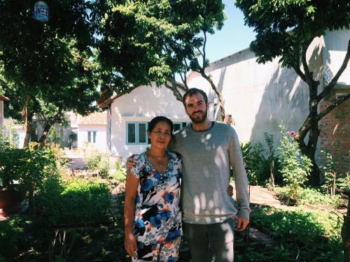 a man and a woman standing in front of a house at Vietnam Phuot Real Home in Kon Tum