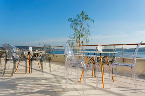 a group of chairs and a table on a balcony at Hotel Ola - Adults Only in Trogir
