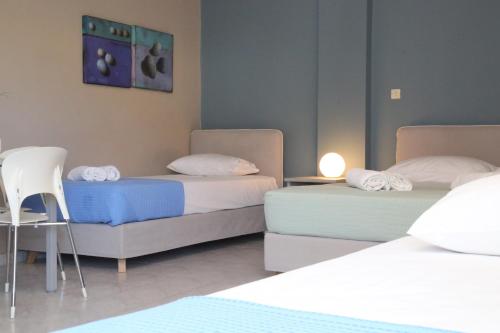 a bedroom with two beds and a table and a chair at Blue Sky in Galissas