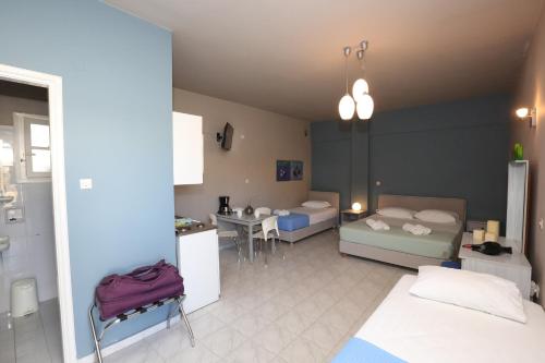 a room with two beds and a table and a kitchen at Blue Sky in Galissas