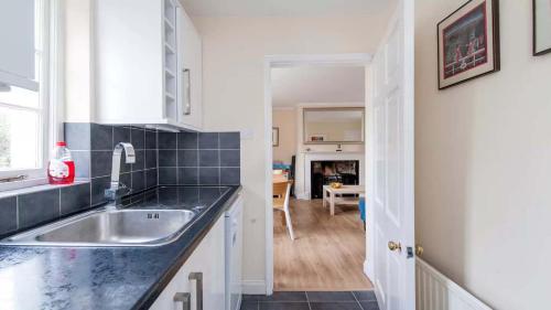 a kitchen with a sink and a counter top at New King Street Apartment in Bath