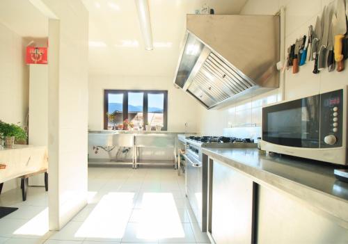 a kitchen with a stainless steel counter and a microwave at The Ghetto in Buşteni