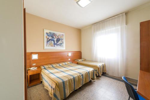 Postel nebo postele na pokoji v ubytování Hotel Moderno