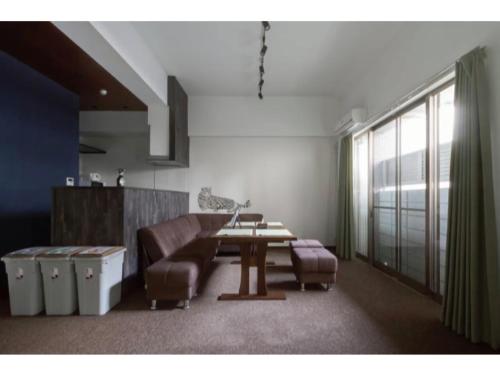 a living room with a couch and a table at The Wonder At Stay-Bentencho- in Osaka
