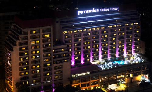 a building with purple lights on it at night at Pyramisa Suites Hotel Cairo in Cairo