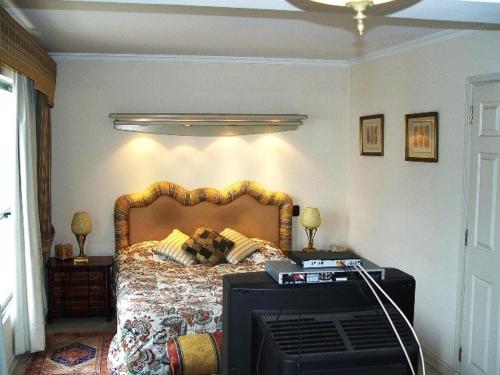 a bedroom with a bed with a television in it at Puerto Pacifico in Viña del Mar