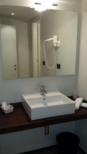 a bathroom with a white sink and a mirror at Hotel San Donato - Bologna centro in Bologna