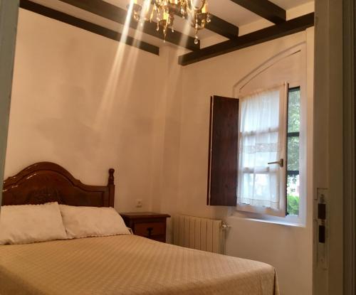 A bed or beds in a room at Apartamentos La Casona