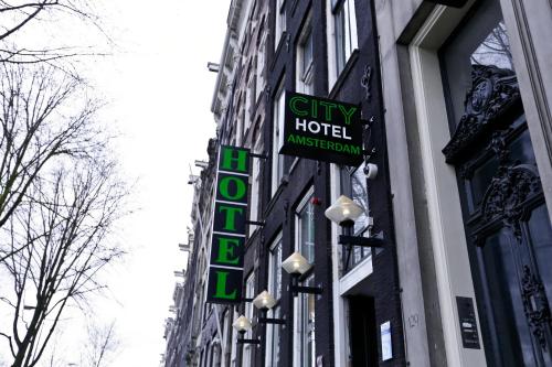 
a street sign on a pole in front of a building at City Hotel Amsterdam in Amsterdam
