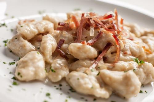 a white plate of food with shrimp and carrots at Agriturismo I Comelli in Nimis