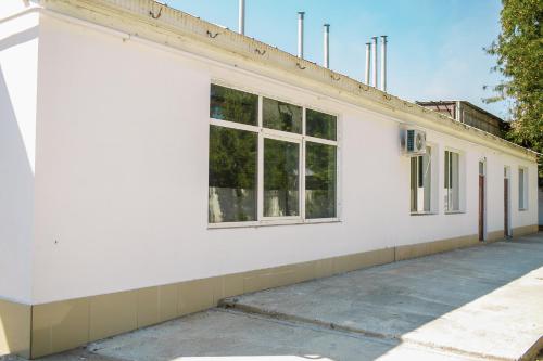 a white building with windows on the side of it at Premium Hotel in Izmail
