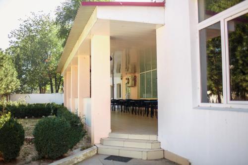 a white house with a porch with a window at Premium Hotel in Izmail