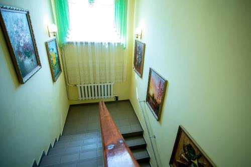a hallway with a staircase with a window and a stair case at Premium Hotel in Izmail