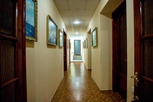 a hallway in a building with paintings on the walls at Premium Hotel in Izmail