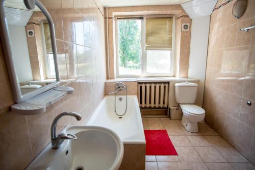 a bathroom with a sink and a toilet and a window at Premium Hotel in Izmail