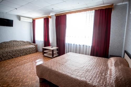 a hotel room with two beds and a window at Premium Hotel in Izmail
