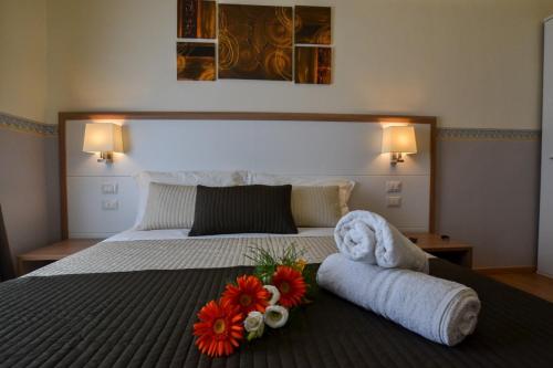 a bedroom with a large bed with flowers on it at B&B AL VIALE in Foggia
