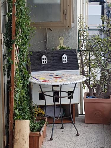 a table with a bird house on it on a balcony w obiekcie B & B Arco di Sole w mieście Pontecagnano