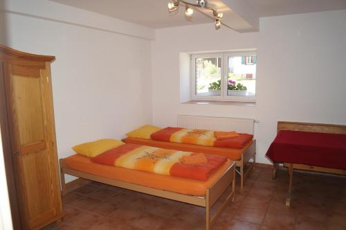 2 Betten in einem Zimmer mit Fenster in der Unterkunft Bolderhof in Hemishofen