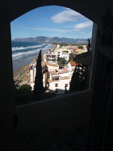 a view of a beach from a window at Florenza Residence in Sperlonga