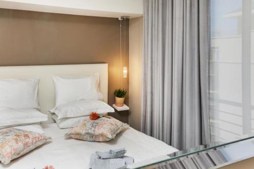 a bedroom with a bed with two pillows and a window at The Odyssee 409 in Cape Town