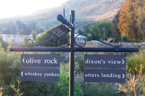 a street sign with directional signs on a pole at White Bridge Farm Accommodation in Wolseley
