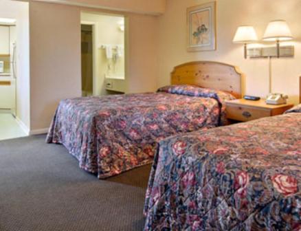 a hotel room with two beds and a telephone at Econo Lodge Franklin in Franklin