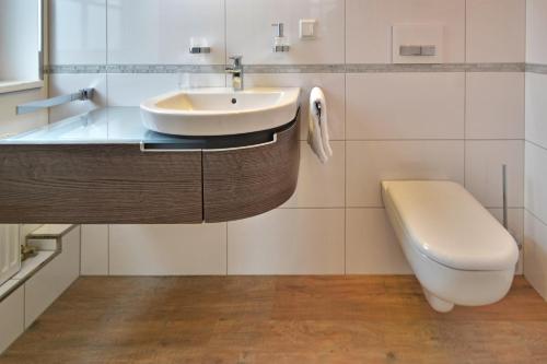 a bathroom with a sink and a toilet at Hotel zur goldenen Sonne in Usingen