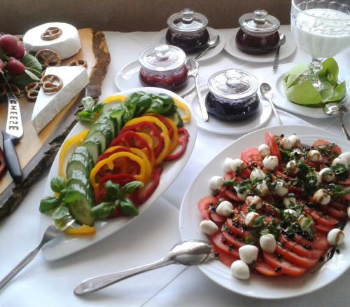 a table topped with plates of food and spoons at Hotel zur goldenen Sonne in Usingen