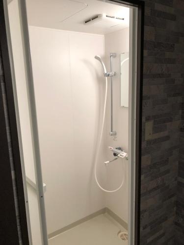 a shower stall in a bathroom with at Umitoyama Hakuba in Hakuba