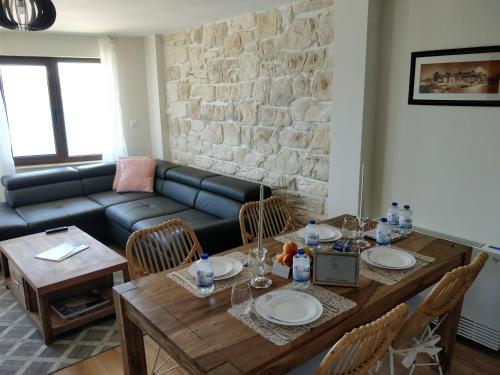 a living room with a table and a couch at Villa Elea in Nesebar