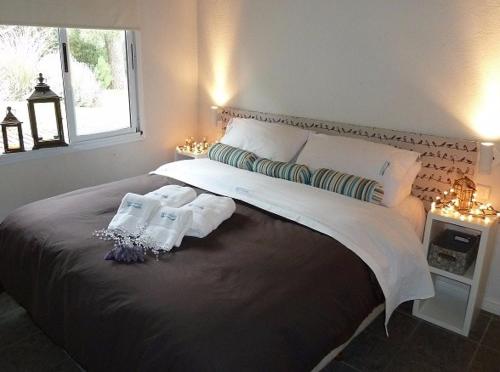 a bedroom with a large bed with two pillows and a window at Aguamansa in Las Gaviotas